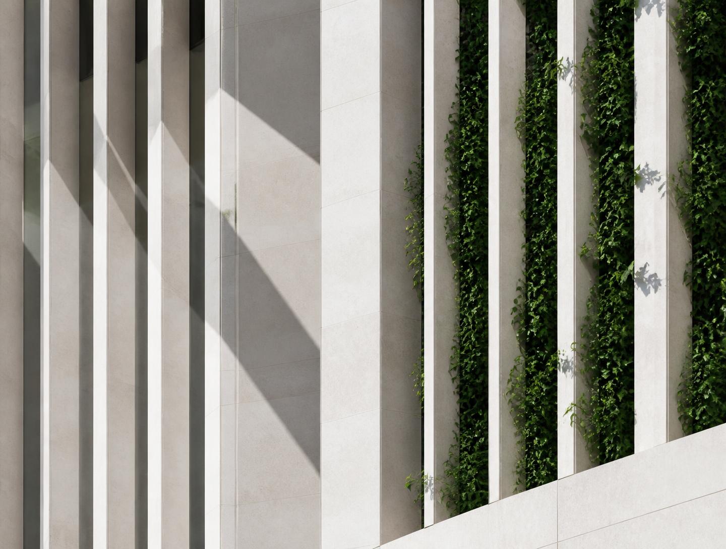 Detail of the stone facade with vertical fins and planting